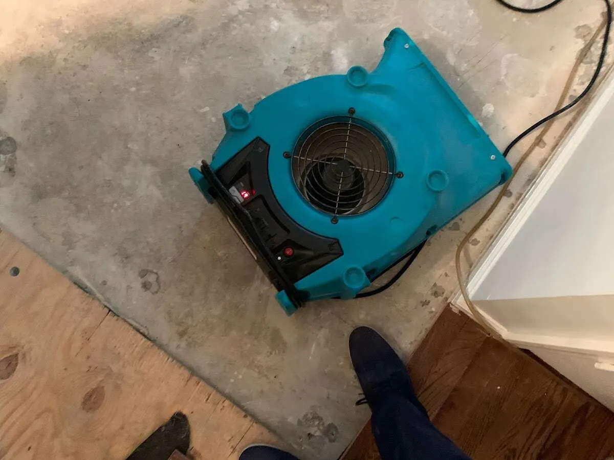 Air mover drying subfloor during Commercial Water Damage Restoration in Eloy